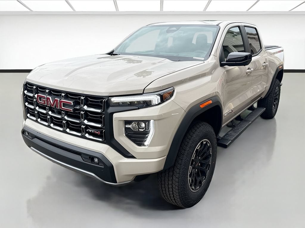2026 GMC Canyon AT4 in Coastal Dune — front three-quarter view